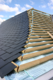 Partially clad exterior of curved steel roof